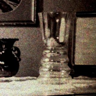 Woman seated at a piano in a vintage interior.