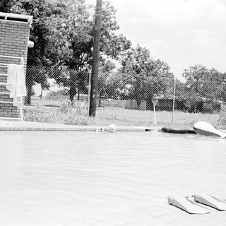 Empty outdoor pool with pool equipment.