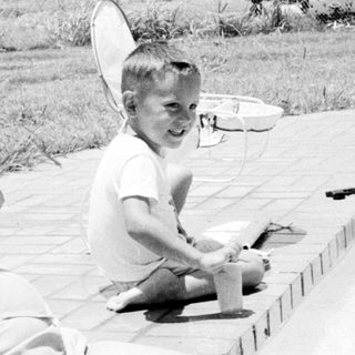 A woman and child by a pool.