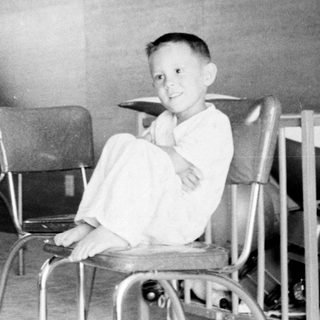 Classroom scene with teacher and young student.