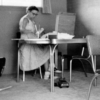 Classroom scene with teacher and young student.