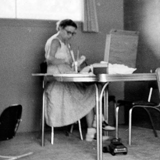Classroom scene with teacher and young student.