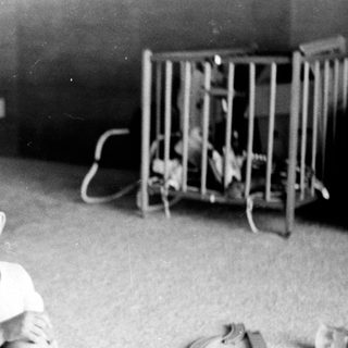 Young boy smiling indoors in playroom setting.