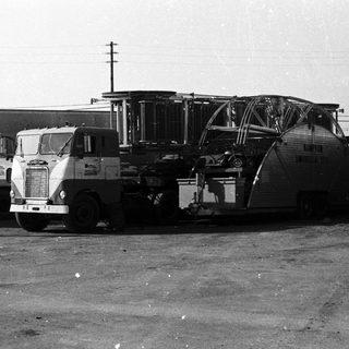 Large truck transporting aircraft engine section.