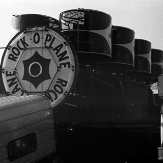Rock band's vintage tour buses with "Plane Rock-O-Plane Rock" branding.