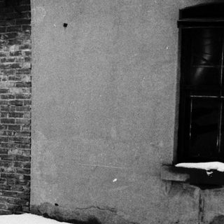 Snowy alleyway with man firing gun.