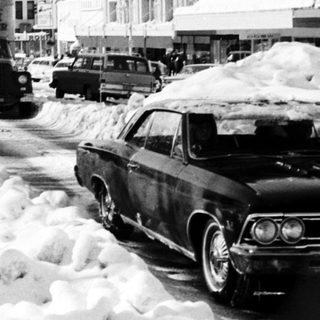 Snow-covered street with heavy snow removal.
