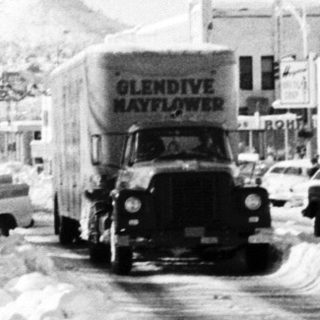 Snow-covered street with heavy snow removal.