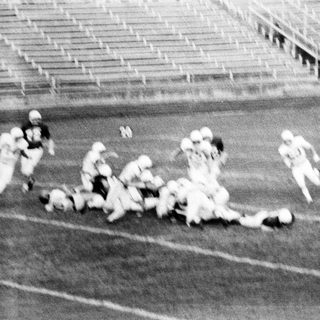 American football game action during play.