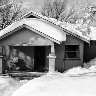 Small house covered in snow, winter scene.