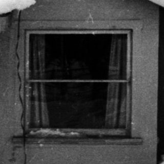Small house covered in snow, winter scene.