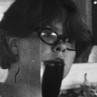Woman drinking coffee at vintage bar counter.