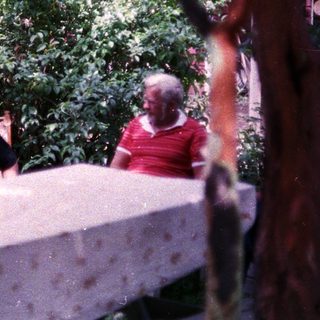 Two people sitting outdoors at a table.