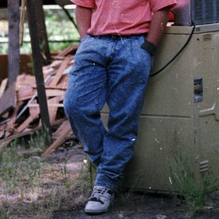 Person smiling outdoors near a generator.