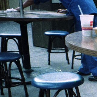 Boy smiling at table with food.