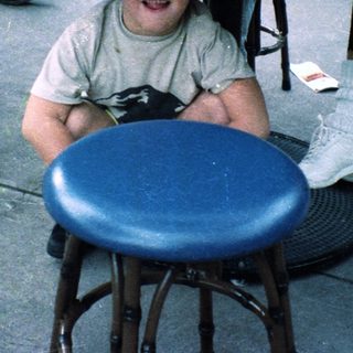 Boy smiling at table with food.