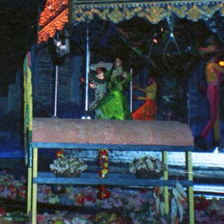 Decorated shrine area during nighttime ceremony.