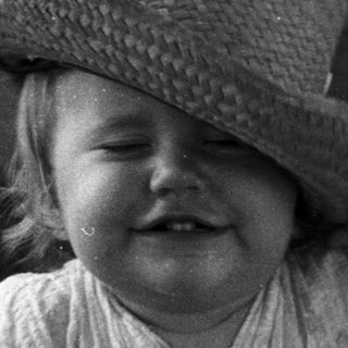 Child smiling while seated in a boat.