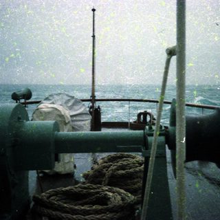 Maritime deck during heavy rain at sea.