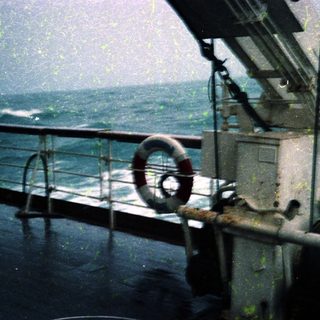 Deck view of a ship during rough seas.