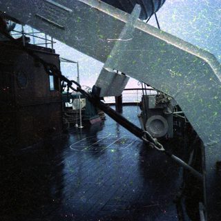 Industrial ship deck with crane and equipment.