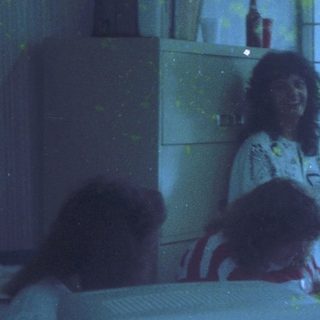 Blurry indoor scene with "Love" written in glittery letters.