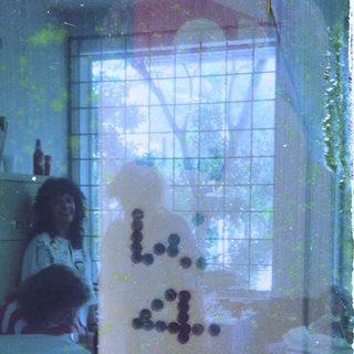 Blurry indoor scene with "Love" written in glittery letters.