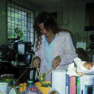 Woman preparing food with ingredients on counter.