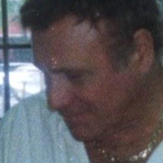 Man eating near buffet table indoors.
