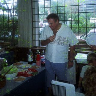 Man eating near buffet table indoors.