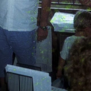 Man eating near buffet table indoors.
