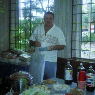 Chef presenting menu with diverse dishes.