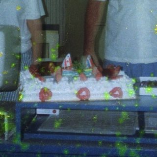 People cutting and serving cake indoors.