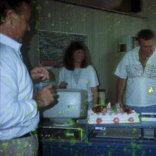 People cutting and serving cake indoors.
