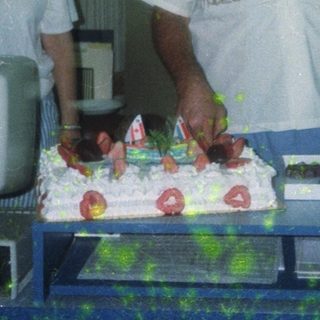 Two people celebrating a birthday with cake.