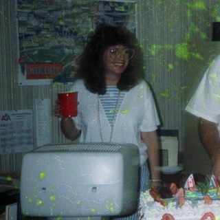 Two people celebrating a birthday with cake.