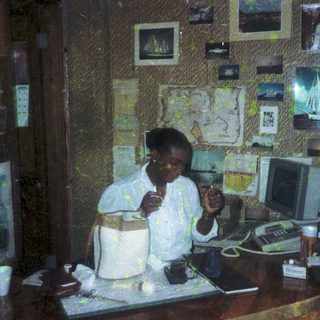 Person in office setting eating cake at desk.