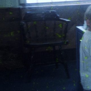 Child standing in messy, painted room.