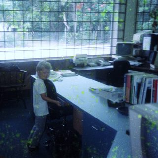 Child standing in messy, painted room.