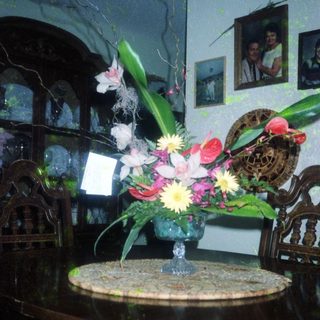 Elegant floral arrangement in vintage vase on table.