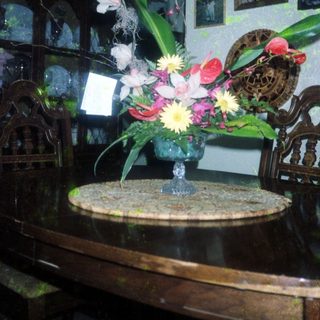 Elegant floral arrangement in vintage vase on table.