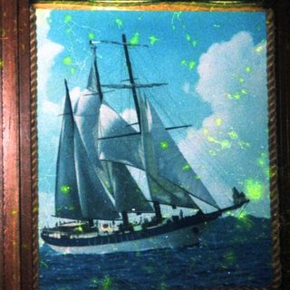 Two vintage sailing ships depicted in framed paintings.