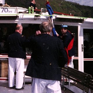 Classic riverboat with passengers enjoying scenic outdoor cruise.