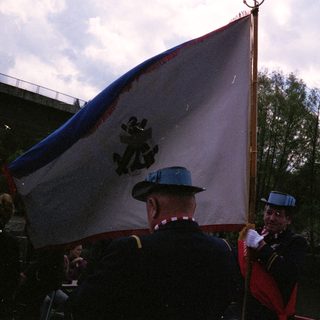 Ceremonial flag parade with uniformed personnel.