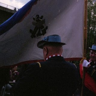 Ceremonial flag parade with uniformed personnel.