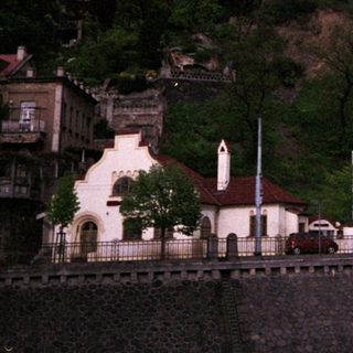 Historic hilltop town with church spires and castle ruins.