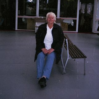 Person sitting on boat deck at dusk.