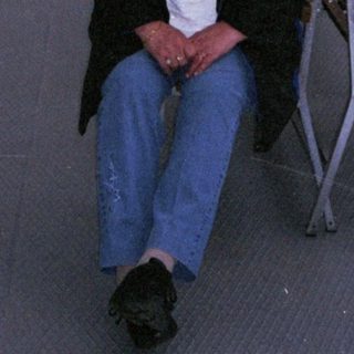 Person sitting on boat deck at dusk.