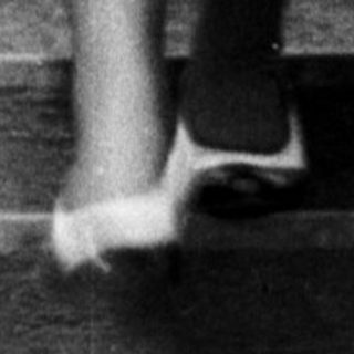 A woman and child walking down stairs together.