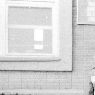 A man and young child standing outside on steps.